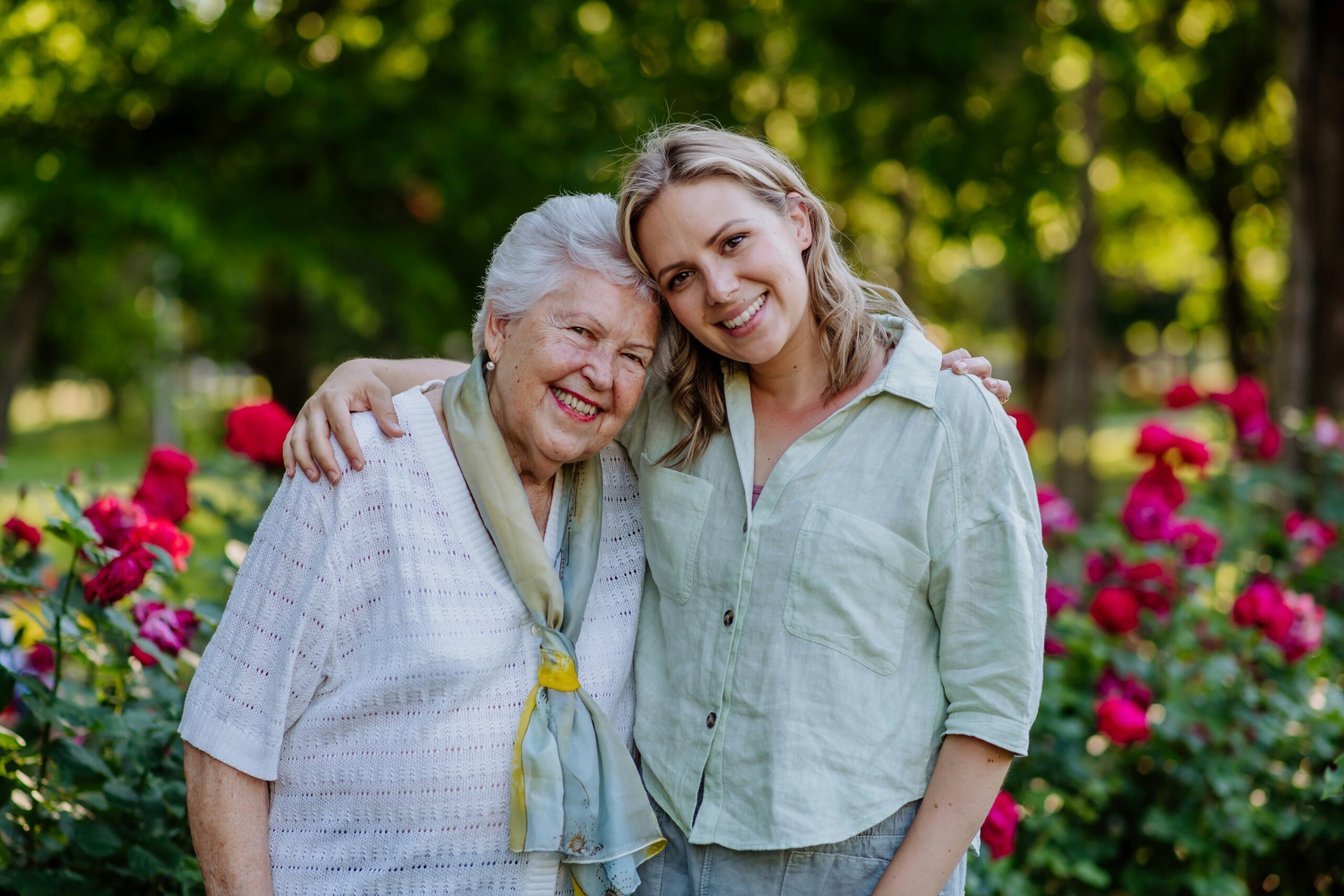 Woman and elderly mother hugging